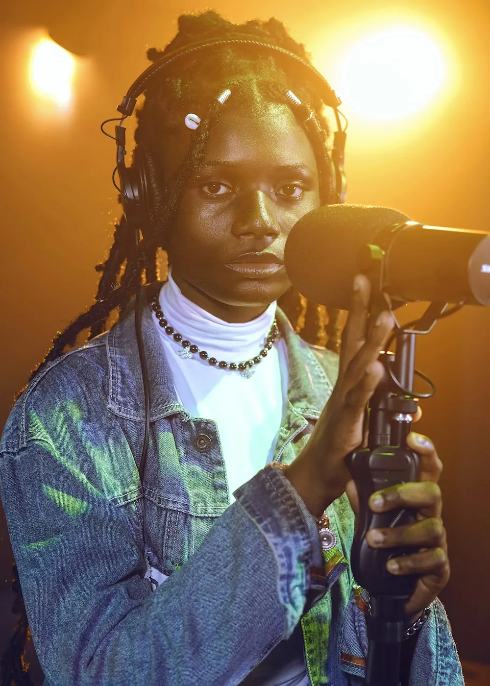 Creator Temi singing into a studio microphone