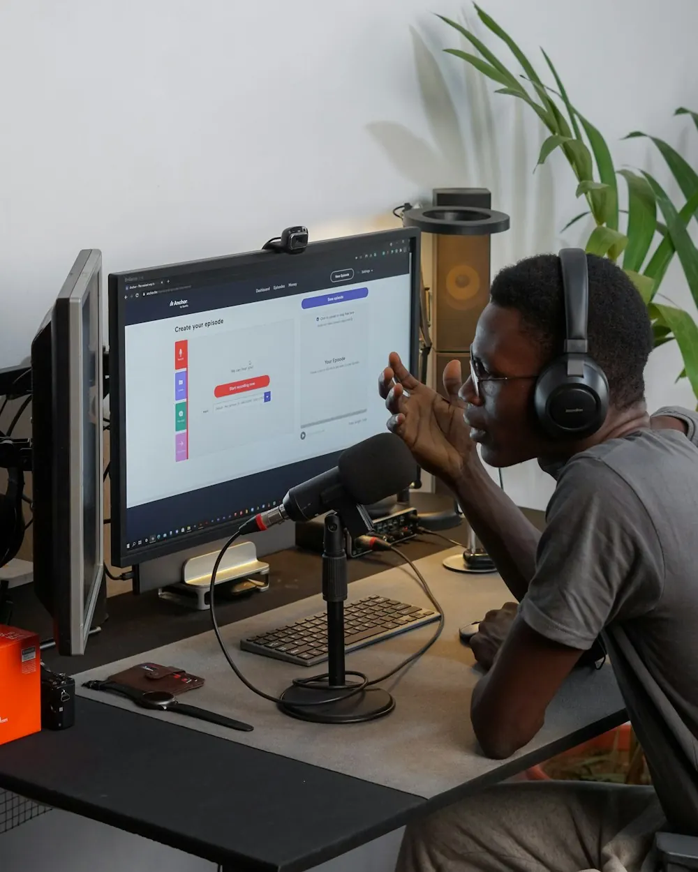 Guest Dami in headphones at his desk