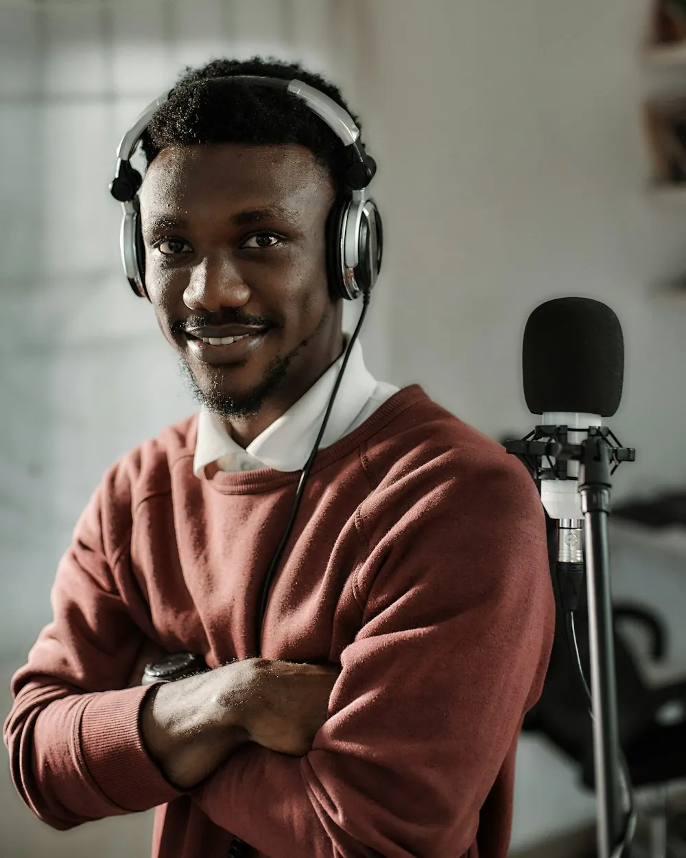 Guest creator Tunde in headphones at his studio microphone